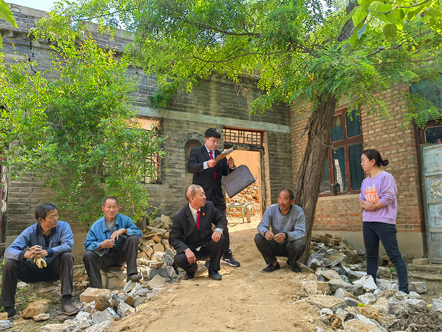 王世廣（左三）與同事對案件進行現場勘驗、調解。魏振敏攝